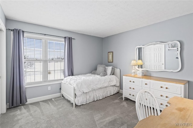 carpeted bedroom with a textured ceiling