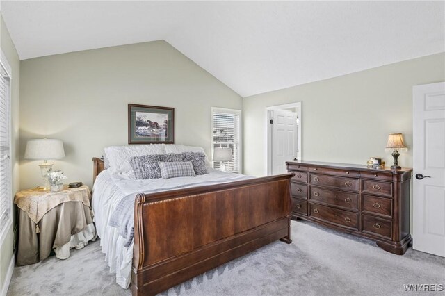 carpeted bedroom featuring vaulted ceiling