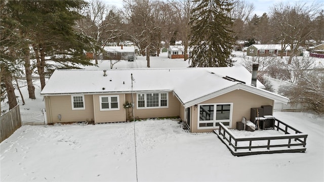 view of snow covered rear of property