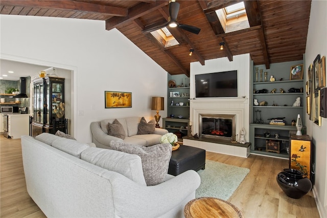 living room with light wood-type flooring, high vaulted ceiling, beam ceiling, wood ceiling, and a skylight