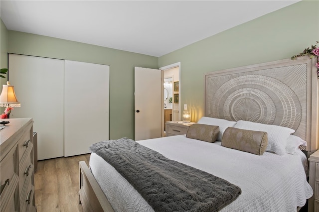 bedroom with light hardwood / wood-style flooring and a closet