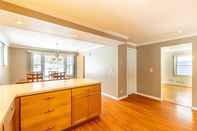 kitchen with decorative light fixtures, crown molding, and light hardwood / wood-style flooring