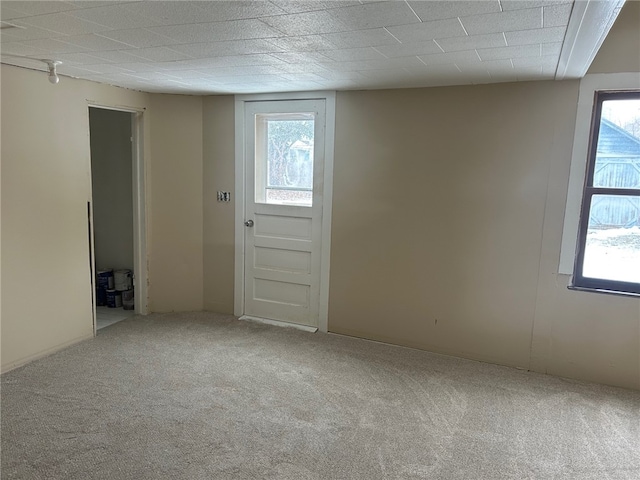 empty room with carpet floors and plenty of natural light