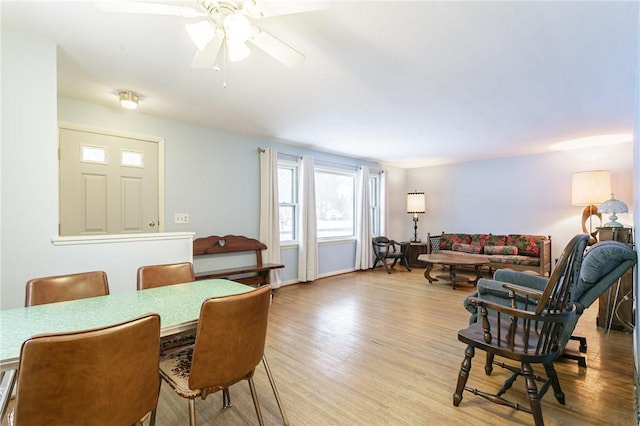 dining space featuring ceiling fan and light wood finished floors