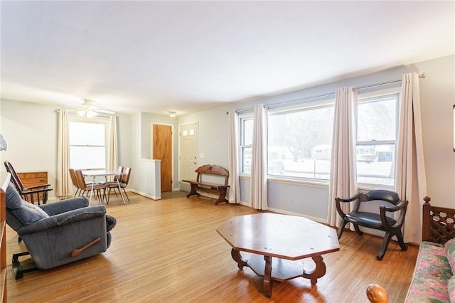 living room featuring light wood-style flooring and a healthy amount of sunlight