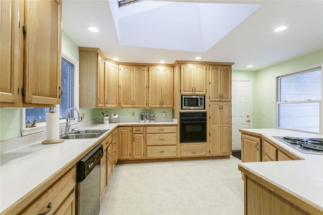 kitchen featuring recessed lighting, light countertops, black appliances, and a sink