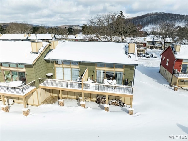 snow covered house with a mountain view