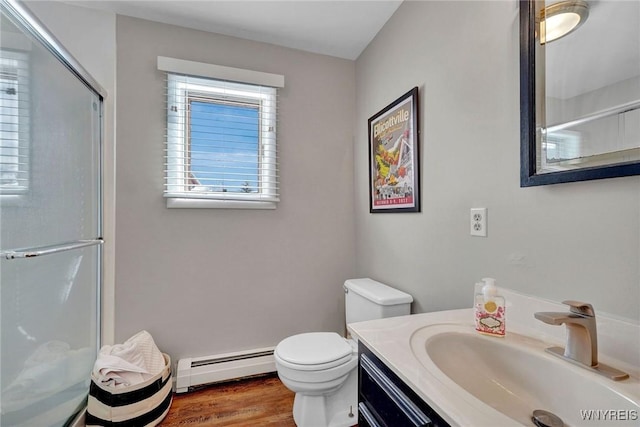 bathroom with vanity, toilet, a baseboard radiator, hardwood / wood-style flooring, and a shower with door