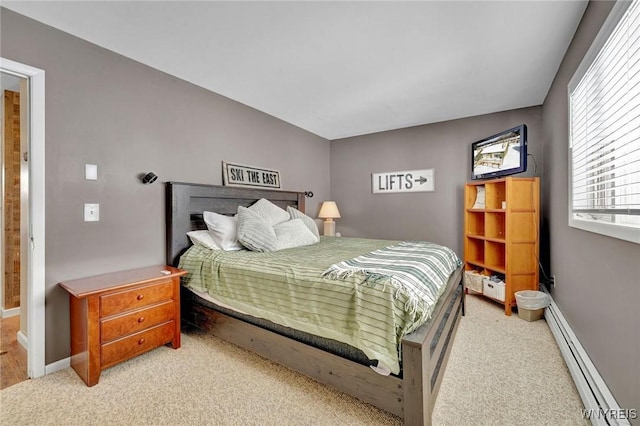 carpeted bedroom featuring a baseboard heating unit