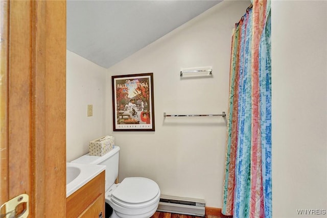 bathroom featuring vanity, toilet, a baseboard heating unit, and lofted ceiling