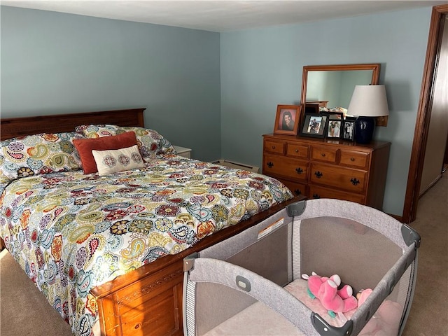 bedroom featuring carpet and a baseboard heating unit