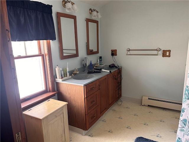 bathroom featuring vanity, plenty of natural light, and baseboard heating