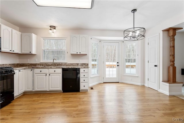 kitchen with pendant lighting, black appliances, light wood-type flooring, and white cabinets