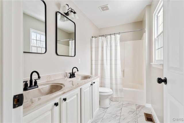 full bathroom featuring marble finish floor, a sink, visible vents, and shower / bathtub combination with curtain