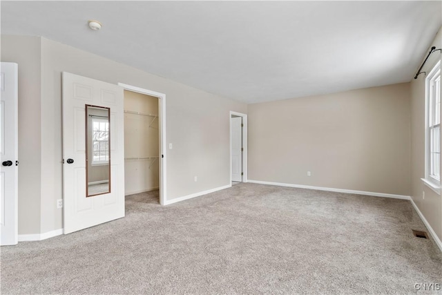 interior space with carpet floors, baseboards, and visible vents