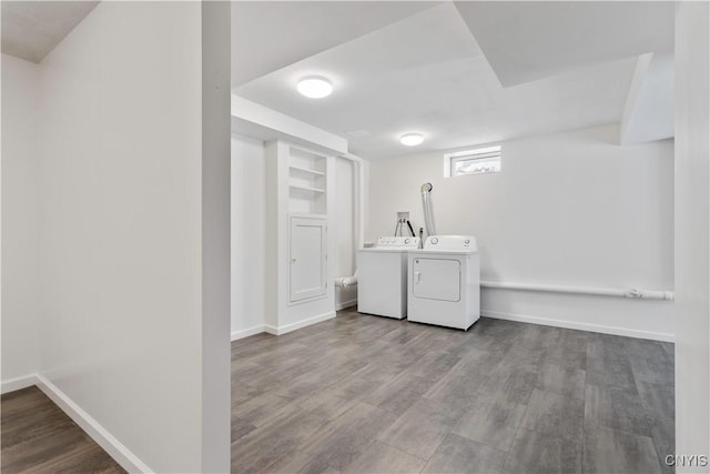 clothes washing area featuring light wood-style floors, laundry area, independent washer and dryer, and baseboards