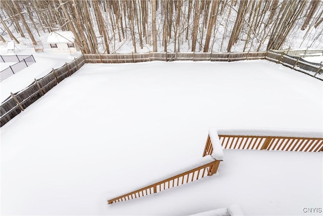 snowy yard with fence