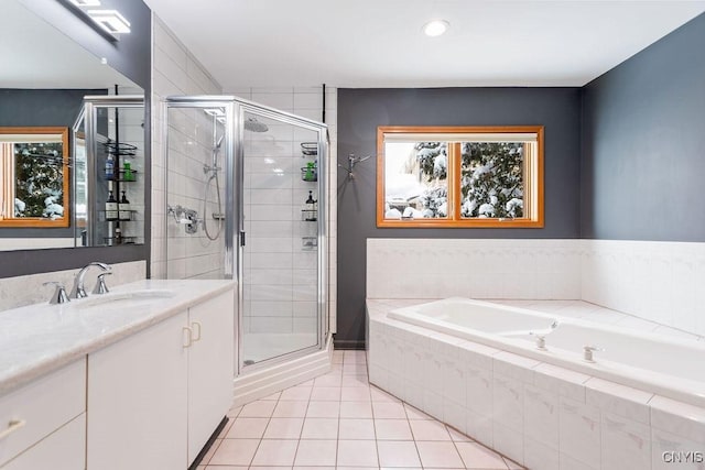 bathroom featuring shower with separate bathtub, tile patterned flooring, and vanity