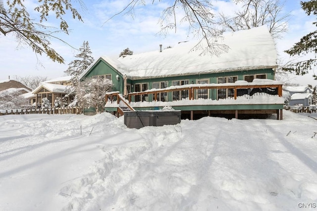 view of snow covered back of property