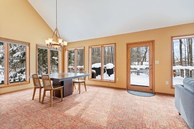 dining room with a notable chandelier, high vaulted ceiling, and carpet