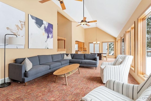 living room with carpet floors, high vaulted ceiling, and ceiling fan with notable chandelier