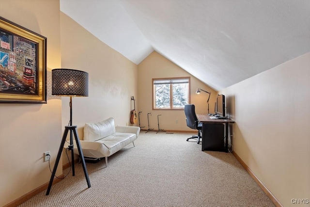 carpeted home office with vaulted ceiling