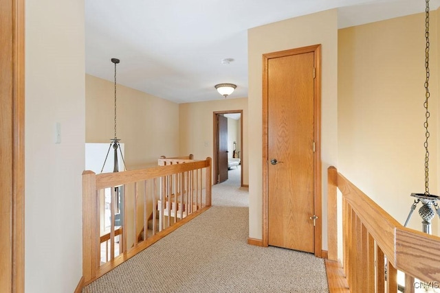 hallway featuring light colored carpet