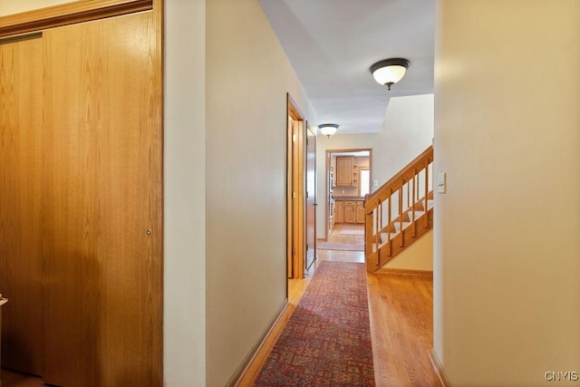 hallway with light hardwood / wood-style flooring