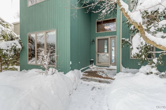 view of snow covered property entrance