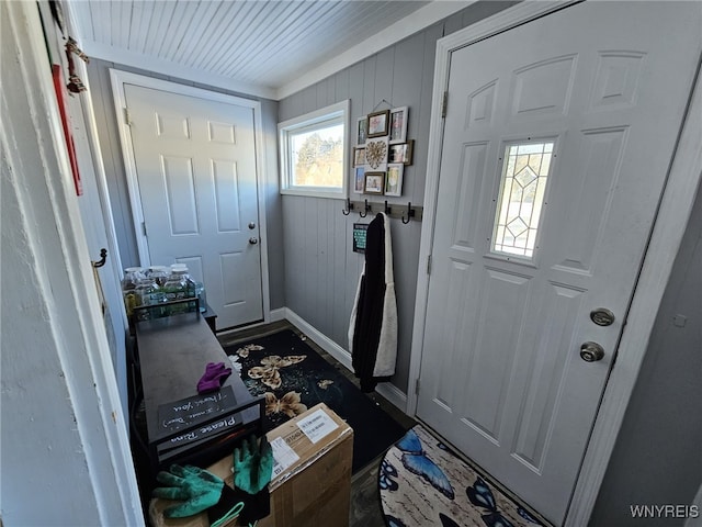 foyer entrance with wooden walls