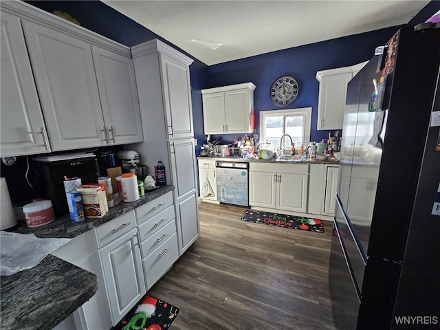 kitchen featuring dishwasher, dark wood-type flooring, white cabinetry, sink, and black fridge