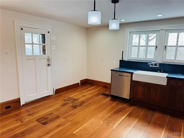 kitchen featuring sink, hardwood / wood-style flooring, pendant lighting, and dishwasher