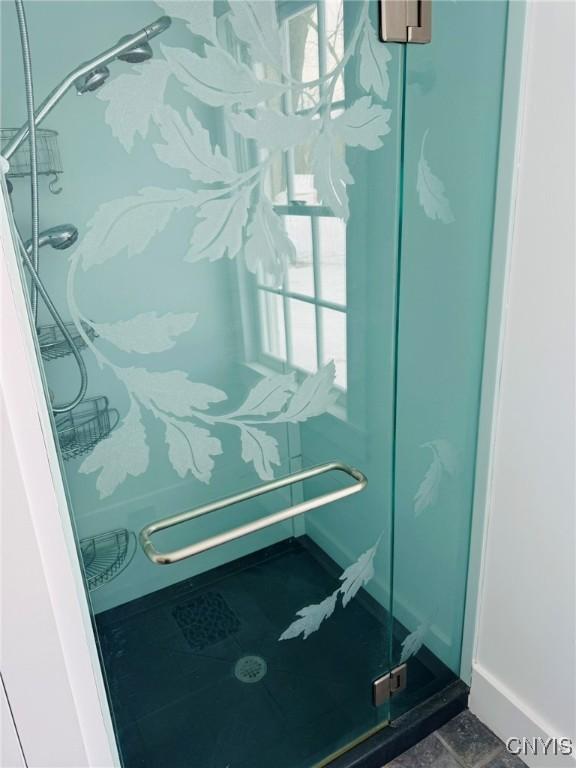 interior space with a shower with door