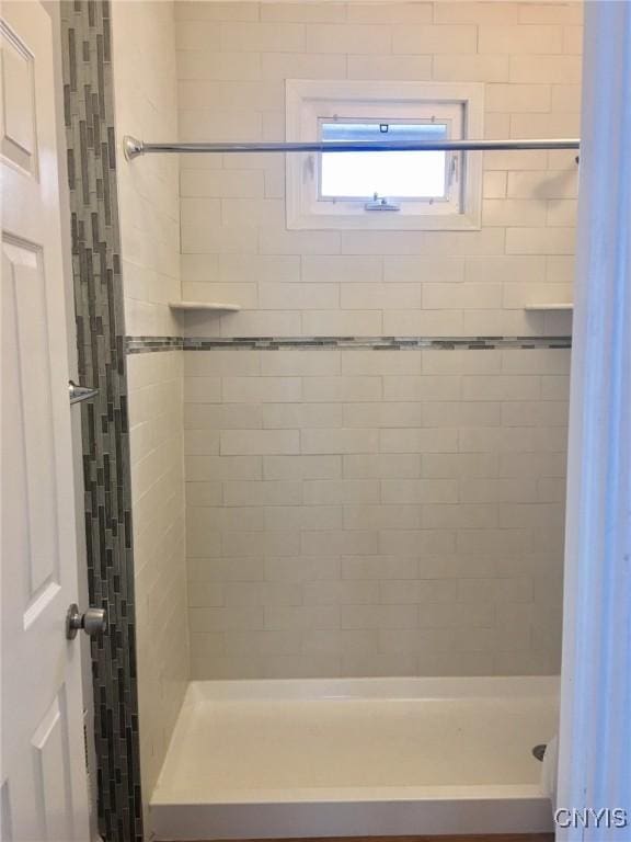 bathroom with tiled shower