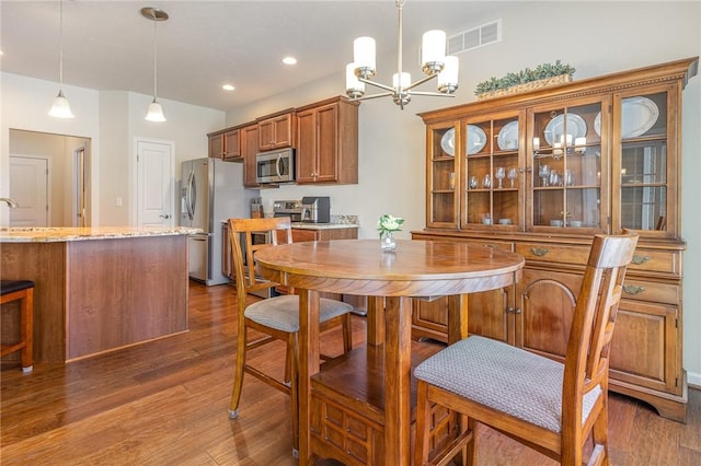 dining room featuring a notable chandelier, sink, and dark hardwood / wood-style floors