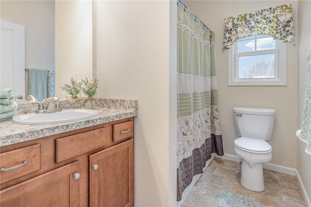 bathroom featuring toilet, curtained shower, and vanity