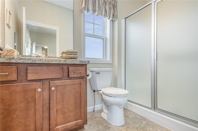 bathroom featuring toilet, vanity, and walk in shower