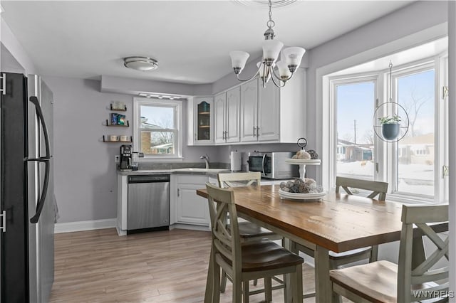 kitchen featuring light wood-type flooring, sink, white cabinets, and stainless steel appliances