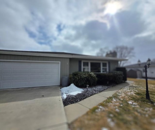 single story home featuring a garage and driveway