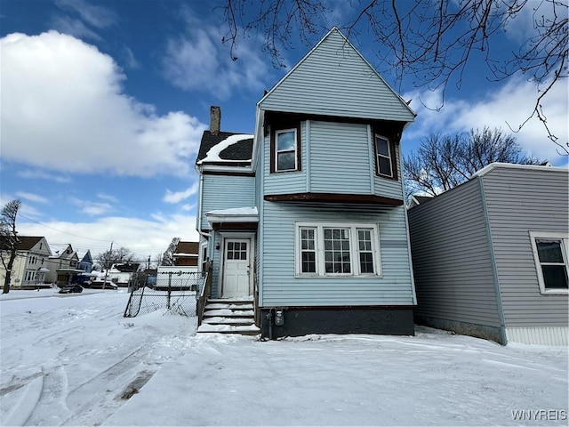 view of snow covered rear of property