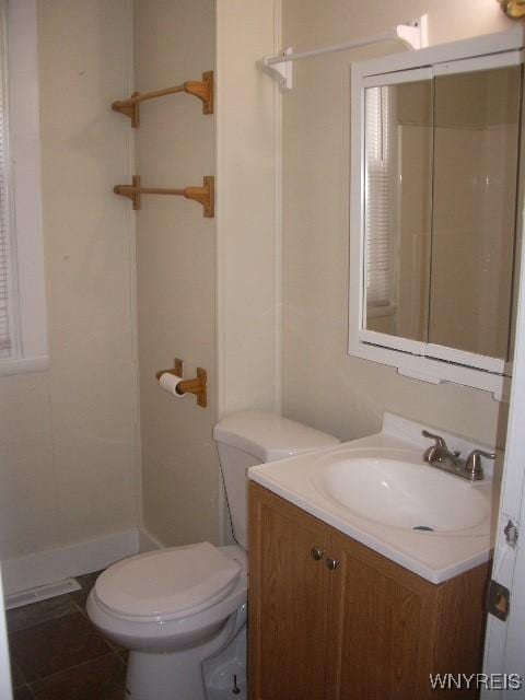 bathroom featuring a shower, toilet, tile patterned flooring, and vanity