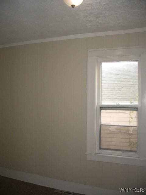 empty room featuring ornamental molding