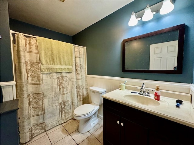 bathroom with vanity, toilet, and tile patterned flooring