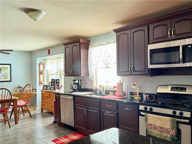 kitchen with ceiling fan, sink, light tile patterned flooring, and stainless steel appliances