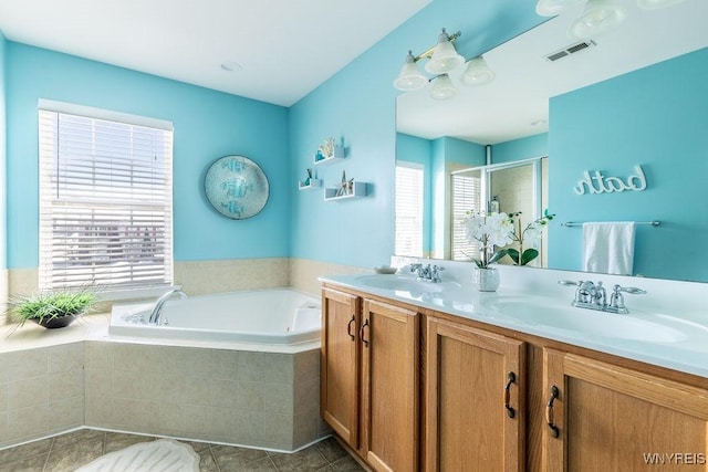 bathroom with separate shower and tub, vanity, and tile patterned floors