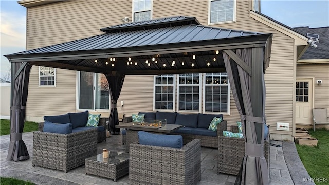 view of patio / terrace with a gazebo and an outdoor living space with a fire pit