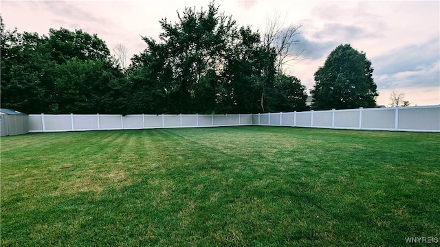 view of yard at dusk