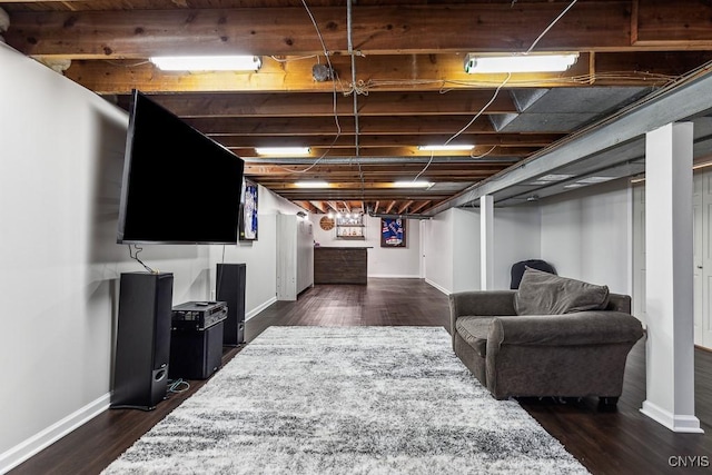 basement featuring dark hardwood / wood-style flooring