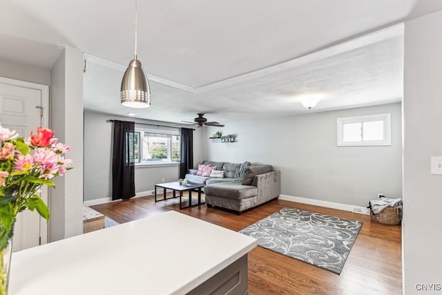 living room featuring dark hardwood / wood-style floors and ceiling fan