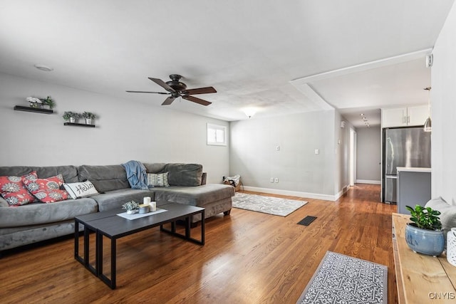 living room featuring hardwood / wood-style floors and ceiling fan